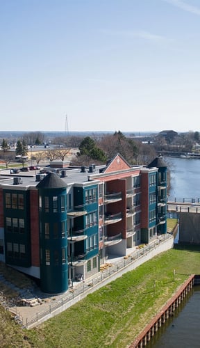 Edgewater condo building on the Manistee River Channel, teal towers and red brick, viewed from above